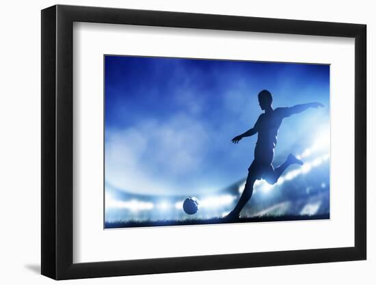 Football, Soccer Match. A Player Shooting on Goal. Lights on the Stadium at Night.-Michal Bednarek-Framed Photographic Print