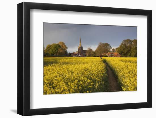 Footpath in rapeseed field to village of Peasemore and St. Barnabas church, Peasemore-Stuart Black-Framed Photographic Print