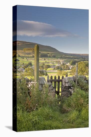 Footpath signpost and gate leading to Hawes village in Wensleydale, The Yorkshire Dales, England-John Potter-Stretched Canvas
