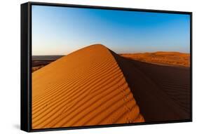 Footprints along the ridge of a sand dune at sunset. Wahiba Sands, Arabian Peninsula, Oman.-Sergio Pitamitz-Framed Stretched Canvas