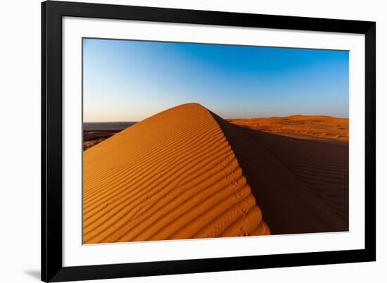 Footprints along the ridge of a sand dune at sunset. Wahiba Sands, Arabian Peninsula, Oman.-Sergio Pitamitz-Framed Photographic Print