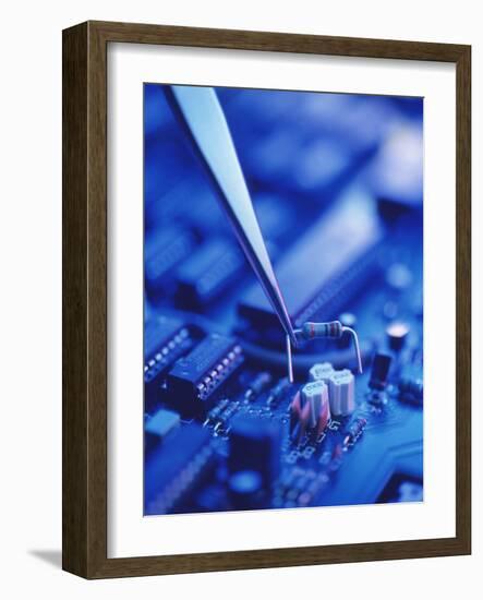 Forceps Holding a Resistor Over a Circuit Board-Chris Knapton-Framed Photographic Print