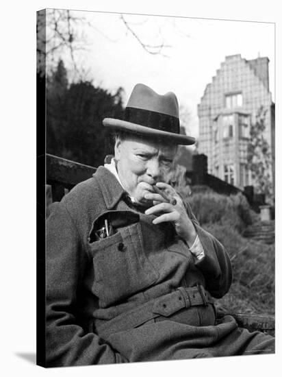 Former Pm Winston Churchill Resting on Bench, Puffing on Cigar, Outside Country Estate Chartwell-Hans Wild-Stretched Canvas