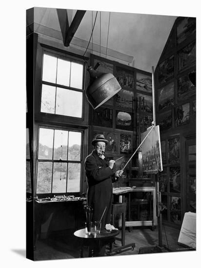 Former PM Winston Churchill Smoking a Cigar in His Studio Dressed in His Blue RAF Siren Jump Suit-Hans Wild-Stretched Canvas