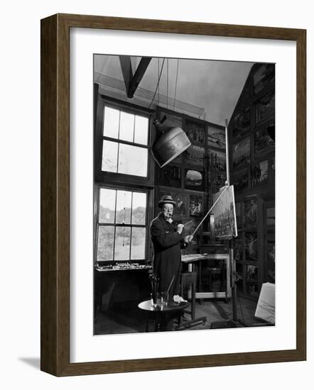 Former PM Winston Churchill Smoking a Cigar in His Studio Dressed in His Blue RAF Siren Jump Suit-Hans Wild-Framed Premium Photographic Print