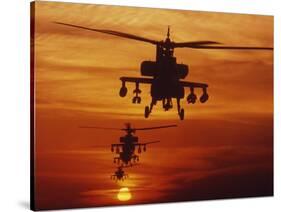 Four AH-64 Apache Anti-armor Helicopters Fly in Formation at Dusk-Stocktrek Images-Stretched Canvas