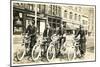 Four Bicyclists Downtown-null-Mounted Art Print