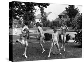 Four Children in Bathing Suits Playing with Water Sprinkler and Running Through Spray on Front Lawn-Alfred Eisenstaedt-Stretched Canvas