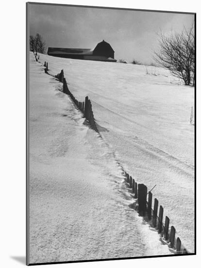 Four Ft. of Snow Almost Covering Up Snow Fence in Front of Barn on the Hill on Upstate Farm-Andreas Feininger-Mounted Photographic Print