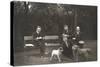 Four Men and Two Dogs in a Garden-null-Stretched Canvas