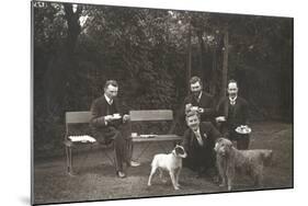 Four Men and Two Dogs in a Garden-null-Mounted Photographic Print