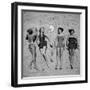 Four Models Showing Off the Latest Bathing Suit Fashions While Lying on a Sandy Florida Beach-Nina Leen-Framed Photographic Print