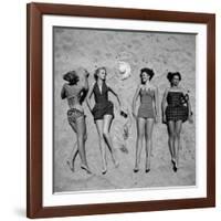 Four Models Showing Off the Latest Bathing Suit Fashions While Lying on a Sandy Florida Beach-Nina Leen-Framed Photographic Print