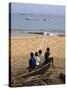 Four Small Boys Look Out to Sea from Where They Sit on Bamboo Fishing Boat on Island of Princip�-Camilla Watson-Stretched Canvas