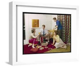 Four Smartly-Dressed Teenagers Having Cocktails around a Record Player-null-Framed Photographic Print