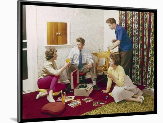 Four Smartly-Dressed Teenagers Having Cocktails around a Record Player-null-Mounted Photographic Print