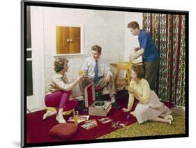 Four Smartly-Dressed Teenagers Having Cocktails around a Record Player-null-Mounted Photographic Print