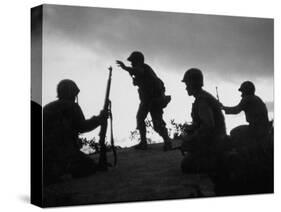 Four Soldiers with Helmets and Rifles Moving on Crest of Ridge, Patroling at Night-Michael Rougier-Stretched Canvas