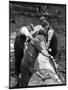 Four Working Class Men in Flat Caps Work as a Team Stripping Bark off a Huge Oak Tree-null-Mounted Photographic Print