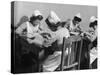 Four Young British Student Nurses Making Notes Together from Medical Textbooks-null-Stretched Canvas