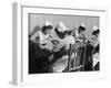 Four Young British Student Nurses Making Notes Together from Medical Textbooks-null-Framed Photographic Print