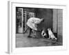 French Actor Jacques Tati Talking to a Couple of Dogs-Yale Joel-Framed Premium Photographic Print
