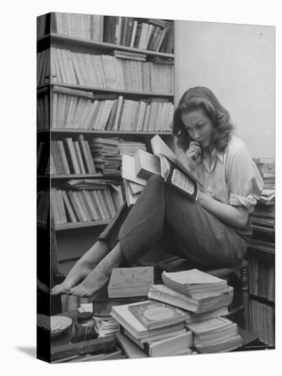 French Actress Barbara Laage, Alone in Her Apartment Reading-Nina Leen-Stretched Canvas