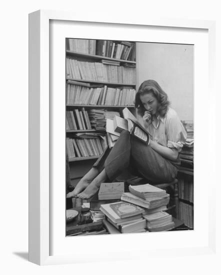 French Actress Barbara Laage, Alone in Her Apartment Reading-Nina Leen-Framed Photographic Print