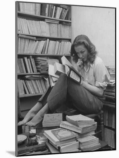 French Actress Barbara Laage, Alone in Her Apartment Reading-Nina Leen-Mounted Photographic Print