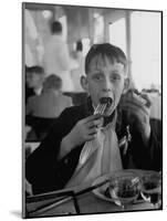 French Boy Andre Poindeeault Mastering a Big Bite-Nat Farbman-Mounted Photographic Print