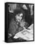 French Novelist Colette, at Desk Covered with Handwritten Notes Topped by Reading Glasses at Home-David Scherman-Framed Stretched Canvas