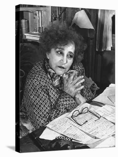 French Novelist Colette, at Desk Covered with Handwritten Notes Topped by Reading Glasses at Home-David Scherman-Stretched Canvas