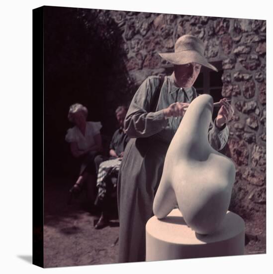 French Sculptor Jean Arp, Alone, Polishing Abstract Sculpture in His Garden Near Paris-Gjon Mili-Stretched Canvas