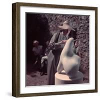 French Sculptor Jean Arp, Alone, Polishing Abstract Sculpture in His Garden Near Paris-Gjon Mili-Framed Premium Photographic Print