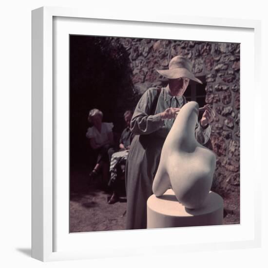 French Sculptor Jean Arp, Alone, Polishing Abstract Sculpture in His Garden Near Paris-Gjon Mili-Framed Premium Photographic Print