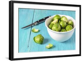 Fresh Brussels Sprouts in White Bowl on Turquoise Wooden Table-Jana Ihle-Framed Photographic Print