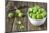 Fresh Brussels Sprouts in White on Wooden Table-Jana Ihle-Mounted Photographic Print