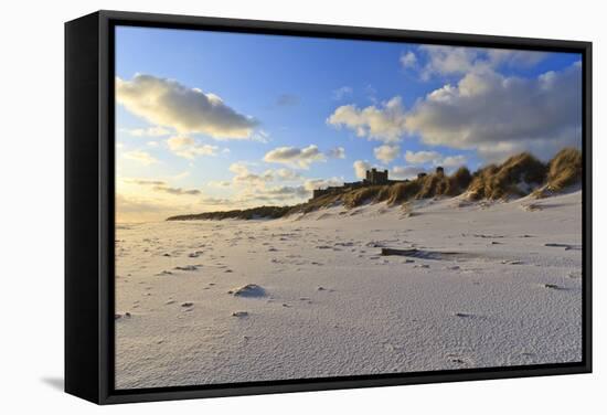 Fresh Spring Snow at Dawn Highlight Ripples and Marks in the Sand Beneath Bamburgh Castle-Eleanor-Framed Stretched Canvas