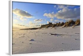 Fresh Spring Snow at Dawn Highlight Ripples and Marks in the Sand Beneath Bamburgh Castle-Eleanor-Framed Photographic Print