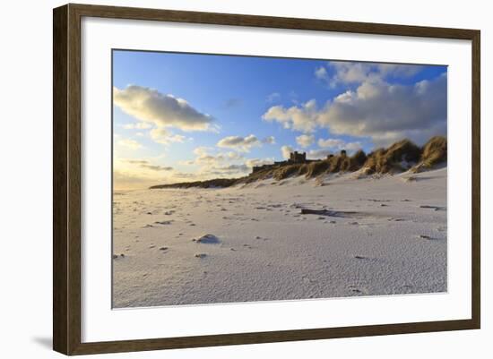 Fresh Spring Snow at Dawn Highlight Ripples and Marks in the Sand Beneath Bamburgh Castle-Eleanor-Framed Photographic Print