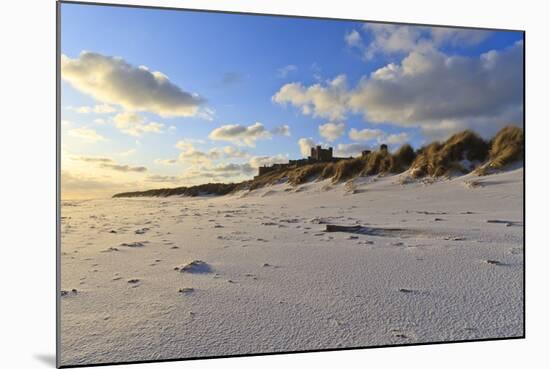 Fresh Spring Snow at Dawn Highlight Ripples and Marks in the Sand Beneath Bamburgh Castle-Eleanor-Mounted Photographic Print