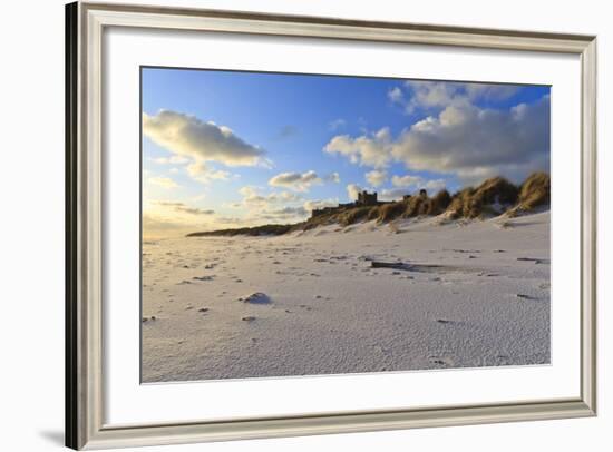 Fresh Spring Snow at Dawn Highlight Ripples and Marks in the Sand Beneath Bamburgh Castle-Eleanor-Framed Photographic Print