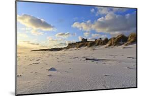 Fresh Spring Snow at Dawn Highlight Ripples and Marks in the Sand Beneath Bamburgh Castle-Eleanor-Mounted Photographic Print