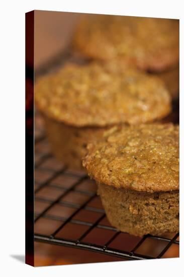 Freshly baked zucchini muffins cooling on a wire rack-Janet Horton-Stretched Canvas