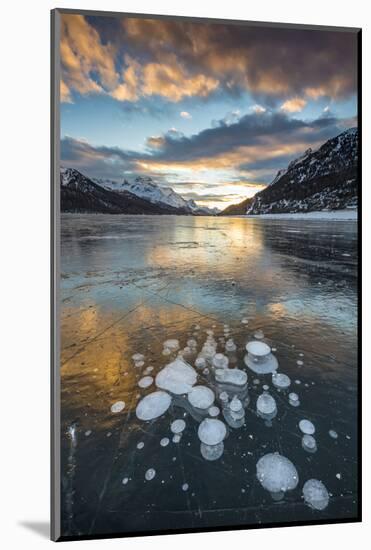Frozen gas bubbles trapped in the ice at sunset. Silvaplana Lake, Silvaplana, Engadin, Graubunden,-ClickAlps-Mounted Photographic Print