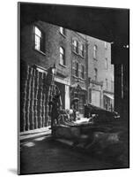 Fruit Baskets Piled Against Houses at Borough Market, London, 1926-1927-Whiffin-Mounted Giclee Print