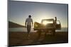 Full Length of Young Couple by Pick-Up Truck Parked on Beach-Nosnibor137-Mounted Photographic Print