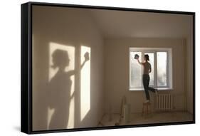 Full Length Rear View of Young Woman Cleaning Window in New Apartment-Nosnibor137-Framed Stretched Canvas