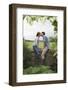 Full Length Side View of a Couple Kissing on Countryside Wall against Landscape-Nosnibor137-Framed Photographic Print