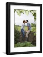 Full Length Side View of a Couple Kissing on Countryside Wall against Landscape-Nosnibor137-Framed Photographic Print